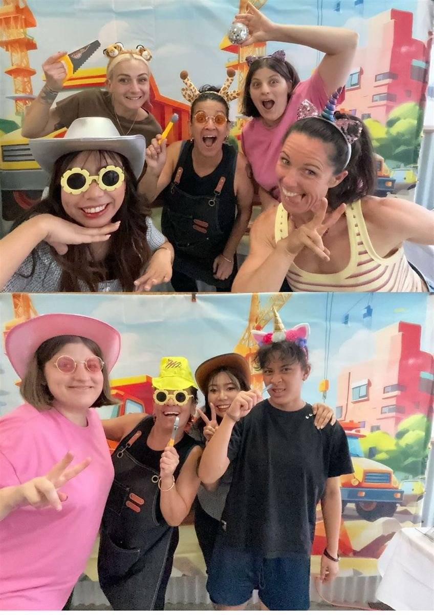 Friends posing with props at a Perth photo booth